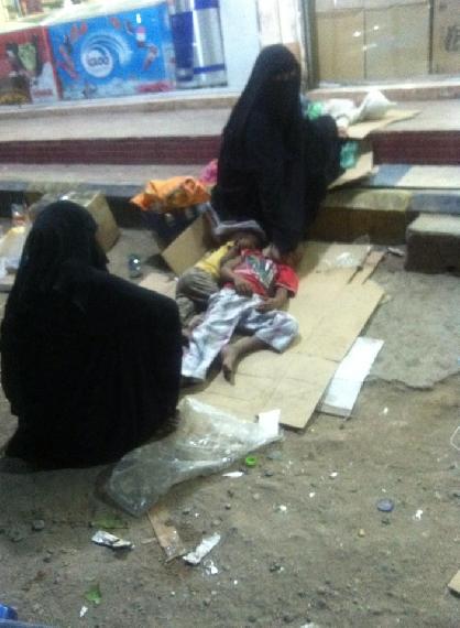 A woman with her children sleeping on the street in Aden.